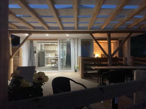 a living room with a wooden ceiling and a table at Hamre Apartments (Nicholas) in Agios Georgios Pagon