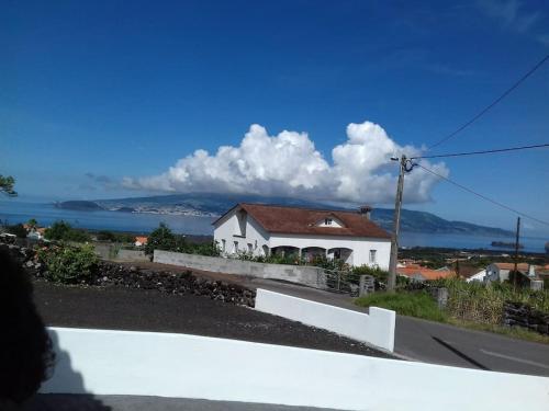 a white house with a view of the ocean at Dream View in Pico in Criação Velha