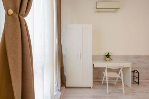 a room with a desk and a table with a chair at Mirabilia Golden in Bologna