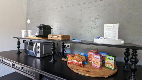 a counter with a table with food on it at Manoir La Cerise in Fougerolles