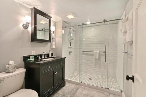 a bathroom with a shower with a glass door at Orleans Square in Savannah
