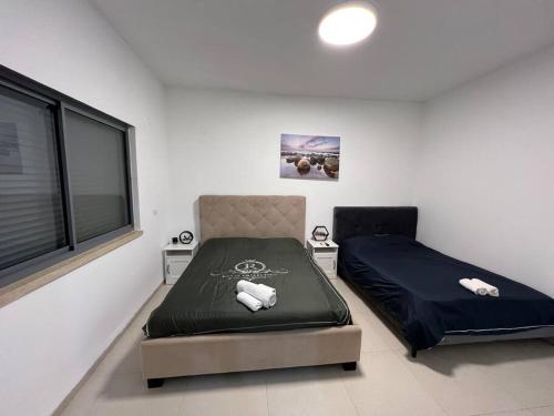 um quarto com uma cama e uma janela em וילת נופש מגידו em Midrakh ‘Oz
