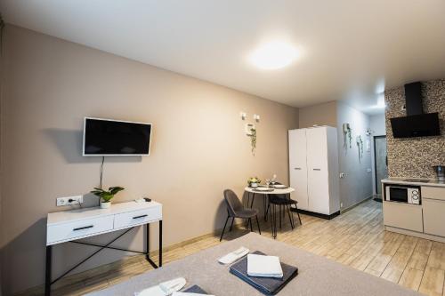 a living room with a kitchen and a table at Aura Home in Dnipro