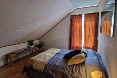 a bedroom with a bed and a window at Central apartment with a view! in Harstad