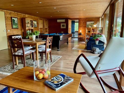 a living room with a table and a pool table at Laimjala Guesthouse with a Cozy Lounge and Terrace in Kurdla