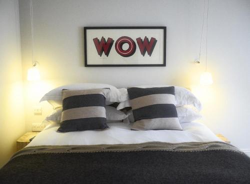a bedroom with a bed with black and white pillows at Timbrell's Yard in Bradford on Avon