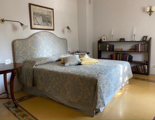 a bedroom with a bed and a book shelf at Burlamacchi Villas in Bagni di Lucca