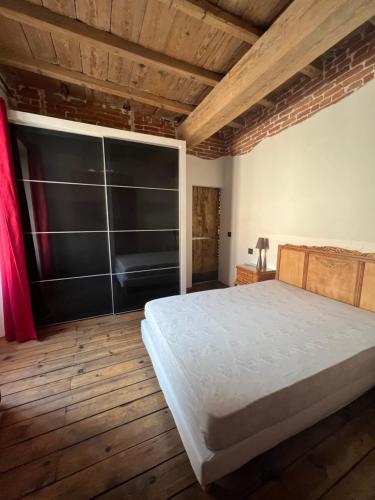 1 dormitorio con 1 cama grande y suelo de madera en Appartement L'Ile-Rousse en LʼÎle-Rousse