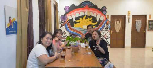 a group of people sitting at a table in a restaurant at Gorga hostel in Timuran