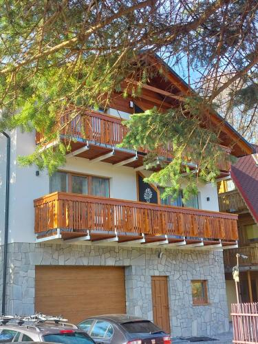 a house with a deck on the side of it at Gal Apart in Szczyrk
