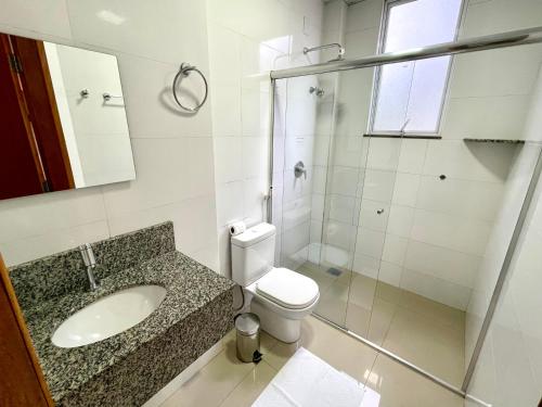 a bathroom with a sink and a toilet at Nav Park Hotel in Naviraí