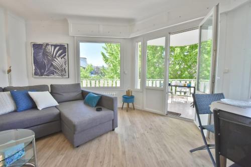 a living room with a couch and a table at City center Cozy flat 5min foot from beaches in Cannes