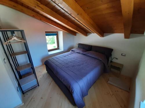 a bedroom with a bed and a mirror in a attic at CASA BRACCALDI in Peveragno