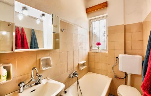 a bathroom with a sink and a toilet and a mirror at Arilena Studios in Paralia Saranti