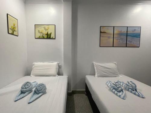 two beds sitting next to each other in a room at Mother’s House in Battambang