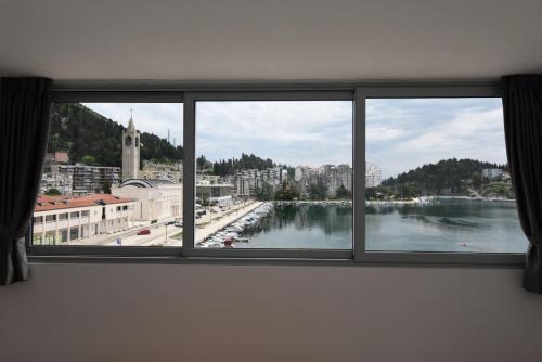 a window with a view of a city and a river at Hotel Tolero in Ploče