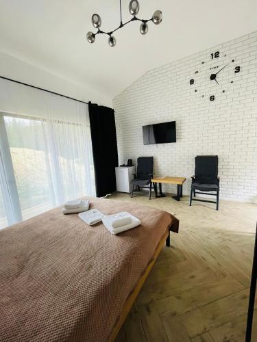 a bedroom with a bed with two towels on it at Шишка in Bukovel