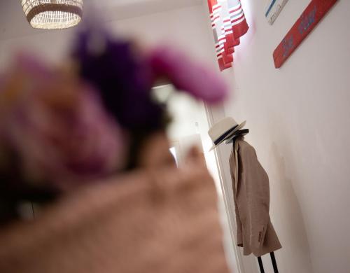 a coat hanging on a wall next to a lamp at Orlando Bayview in Balestrate
