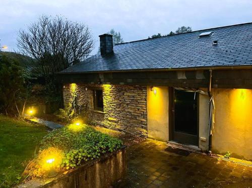 a brick house with lights in front of it at La Maison Ardoise in Herbeumont