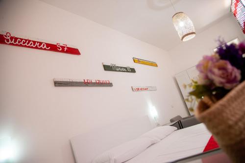 a room with a bed and signs on the wall at Orlando Bayview in Balestrate