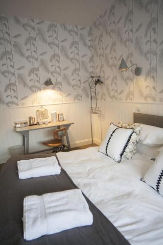 a bedroom with a bed with towels on it at Timbrell's Yard in Bradford on Avon
