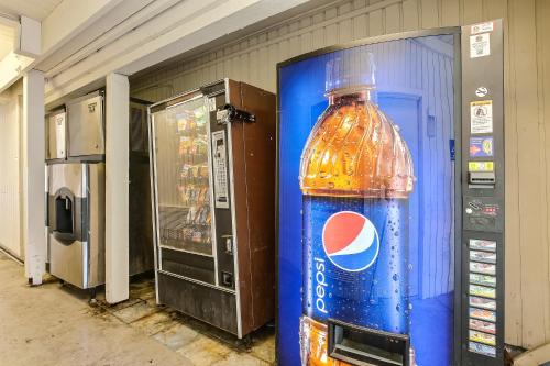 a bottle of water is sitting next to a vending machine at Motel 6-Oakland, CA - Embarcadero in Oakland