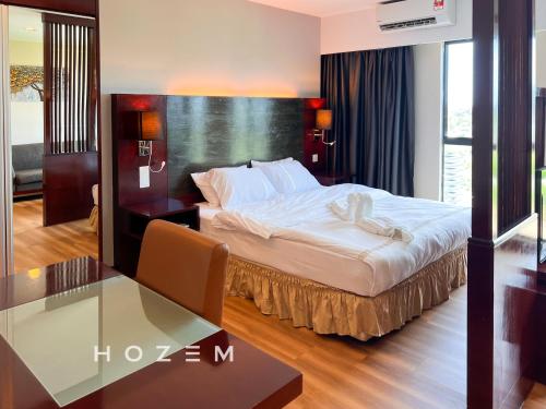 a bedroom with a bed and a glass table at 1BR1B Hozem KK0951 Apartment CBD in Kota Kinabalu