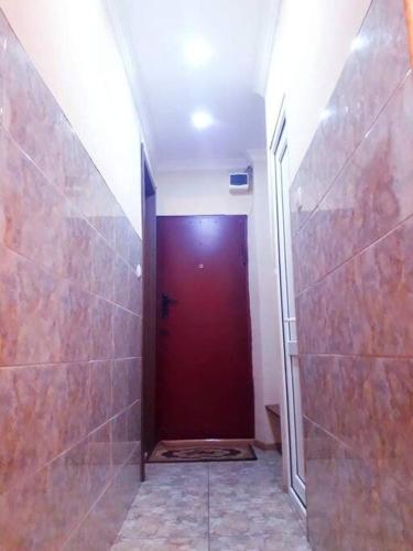 a bathroom with a red door and a walk in shower at Apartment in Kutaisi Chavchavadze in Kutaisi