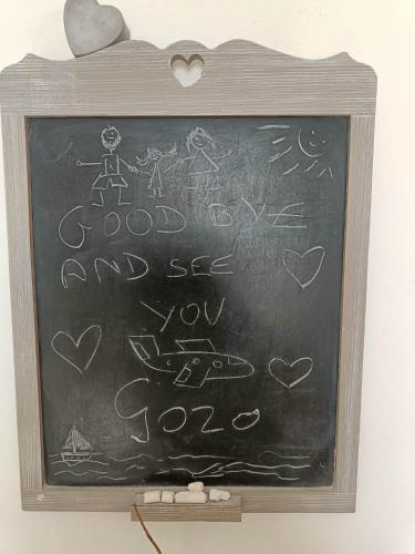 a chalkboard with a bunch of writing on it at Seaview Luxury Penthouse with Shared Swimming Pool in Għajnsielem