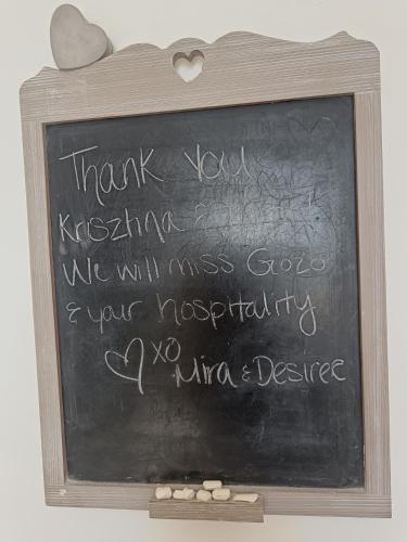 a chalkboard with a thank you sign in a wooden frame at Seaview Luxury Penthouse with Shared Swimming Pool in Għajnsielem