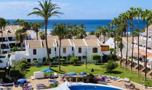 an aerial view of a resort with a pool and palm trees at Penthouse Las Americas first line de lux in Arona