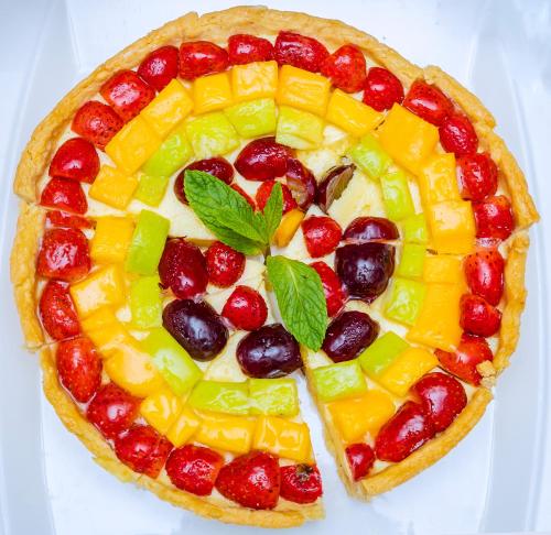 a fruit pie sitting on top of a white plate at M Hotel Kigali in Kigali