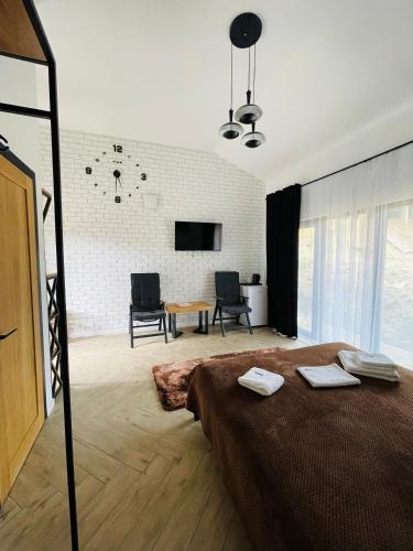 a bedroom with a bed and a table and chairs at Шишка in Bukovel