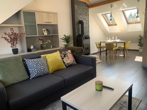 a living room with a couch and a table at Relax & Active Apartment Tábor in Tábor