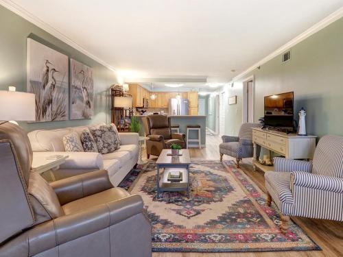 a living room with a couch and a table at Stay-A-While in Tybee Island
