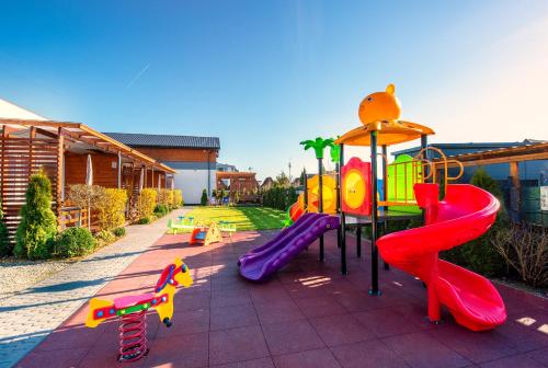 a playground with a slide at Sunrise-Sarbinowo domki i apartamenty in Sarbinowo