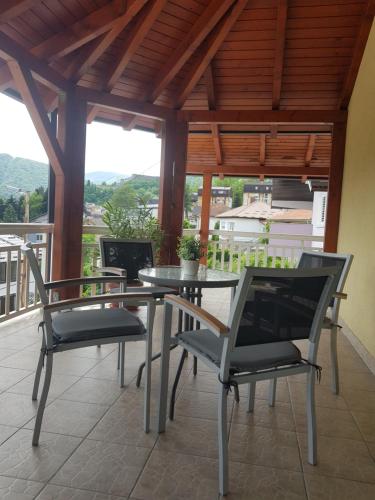 a patio with a table and chairs on a balcony at Apartman Buongiorno in Jajce