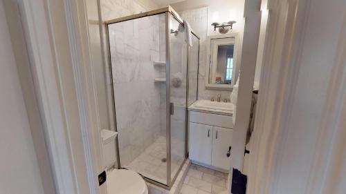 a bathroom with a shower and a toilet and a sink at Suite Escape in Savannah