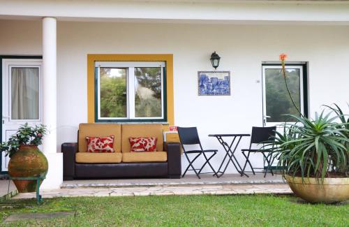 a couch on the front porch of a house at Hotel Louro in Óbidos