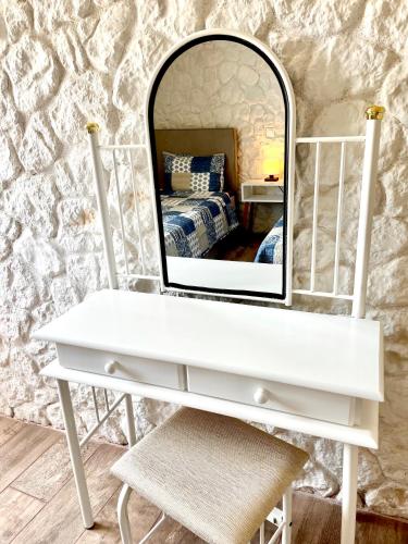 a white dressing table with a mirror on top of it at Hamre Apartments (Nicholas) in Agios Georgios Pagon