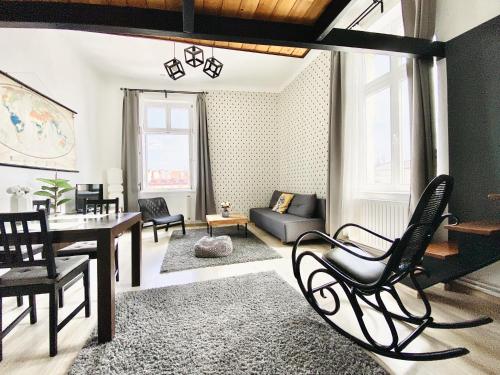 a living room with a couch and a table and chairs at GREEN APARTMENTS #Nowy Square, Kazimierz district in Kraków