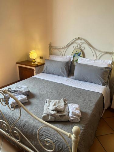 a bedroom with a bed with towels on it at CASA LUCIO in Grosseto