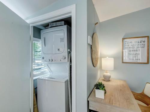 a kitchen with a refrigerator and a washer and dryer at Walking on Sunshine in Tybee Island