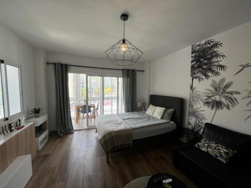 a living room with a bed and a couch at Lux Apartment BY NAMASTE ELITE in Torremolinos