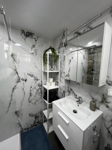 a white bathroom with a sink and a mirror at Lux Apartment BY NAMASTE ELITE in Torremolinos