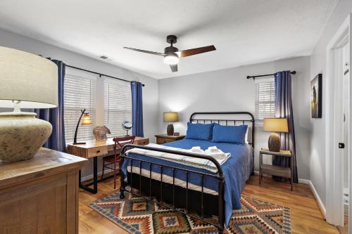 a bedroom with a blue bed and a desk at Stairway to Heaven in Blowing Rock