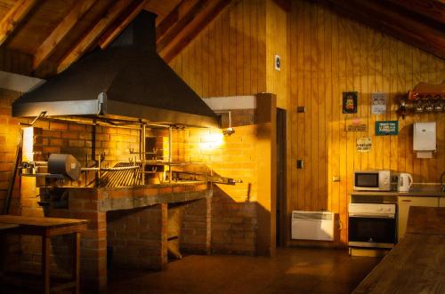 a kitchen with a stove top oven in a room at Hotel Departamentos del Sur in Puerto Montt