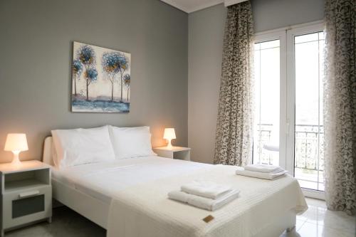 a bedroom with a white bed and a window at Raptis Guest House in Tsilivi