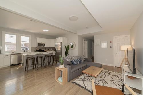 a living room with a couch and a kitchen at Urban Oasis in beautiful East Rock Free Parking Yale adjasent in New Haven