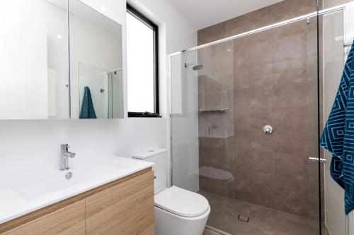 a bathroom with a shower and a toilet and a sink at Luxury private ensuite room close to Airport,City, Genelg Beach in Plympton